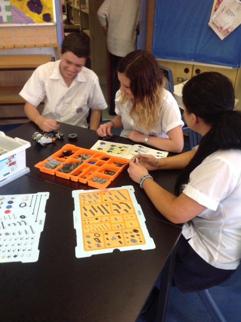 Students using Lego robotics software and hardware
